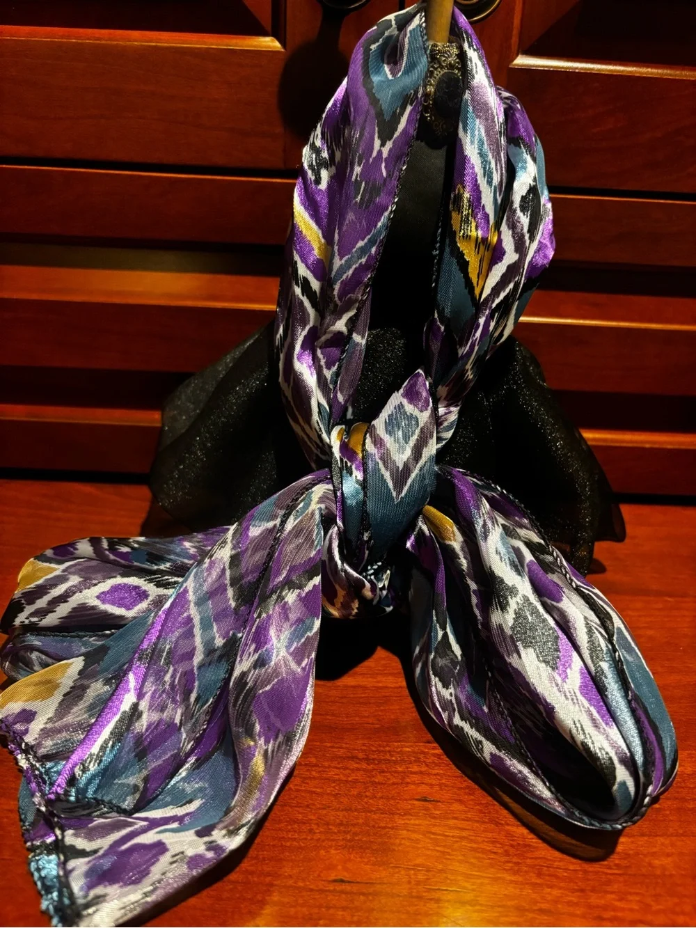 satin scarf featuring a vibrant purple and teal abstract ikat chevron